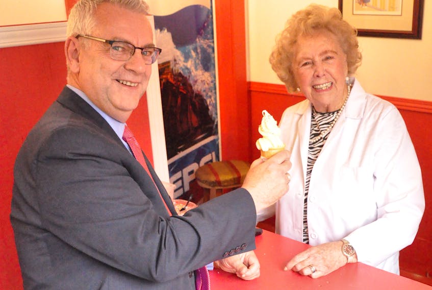 Winnie Crocker serves a custard cone to St. John’s Mayor Danny Breen Thursday at the Newfoundland Embassy on Gower Street, a little wooden building that was once home for Lar’s Fruit Market.