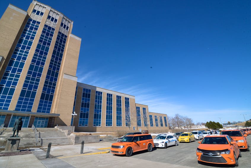 Taxi drivers gather outside Confederation Building Thursday to protest the high insurance rates their industry faces.