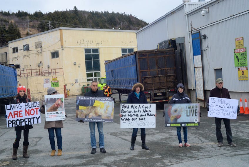Members of the St. John’s Farm Animal Save group stand outside the Country Ribbon facility on East White Hills Road in Pleasantville on Thursday to protest the processing of chickens.