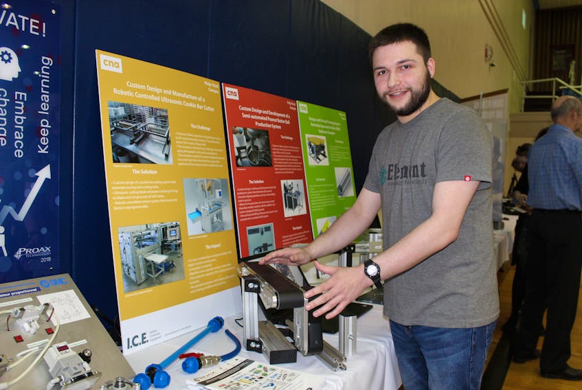 Corey Drover, a former mechanical engineering student at the College of the North Atlantic’s Prince Philip Drive campus, explains how a robotic-controlled ultrasonic cookie cutter is used for peanut butter balls at Chatman’s Bakery in Charlottetown. Drover teamed up with Proax, CNA and Chatman’s on the project.