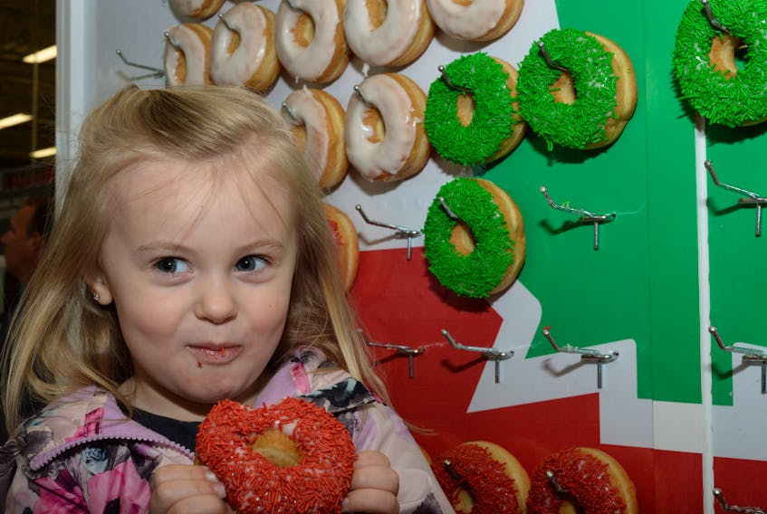 Lydia Shea, 3, of Portugal Cove-St. Philip’s enjoys a donut Thursday morning at the Canadian Tire outlet on Kelsey Drive in St. John’s.