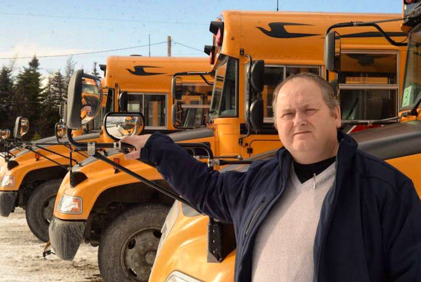 Jim Kelloway, owner of Kelloway Investments Ltd., with some of his school buses at his bus depot in Flatrock.