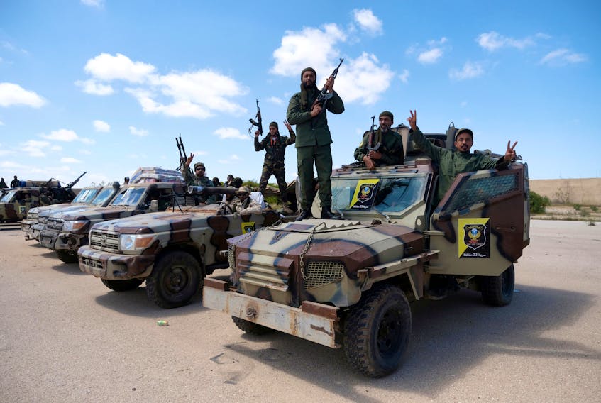 Libyan National Army (LNA) members, commanded by Khalifa Haftar, pose for a picture as they head out of Benghazi to reinforce the troops advancing to Tripoli, in Benghazi, Libya April 7