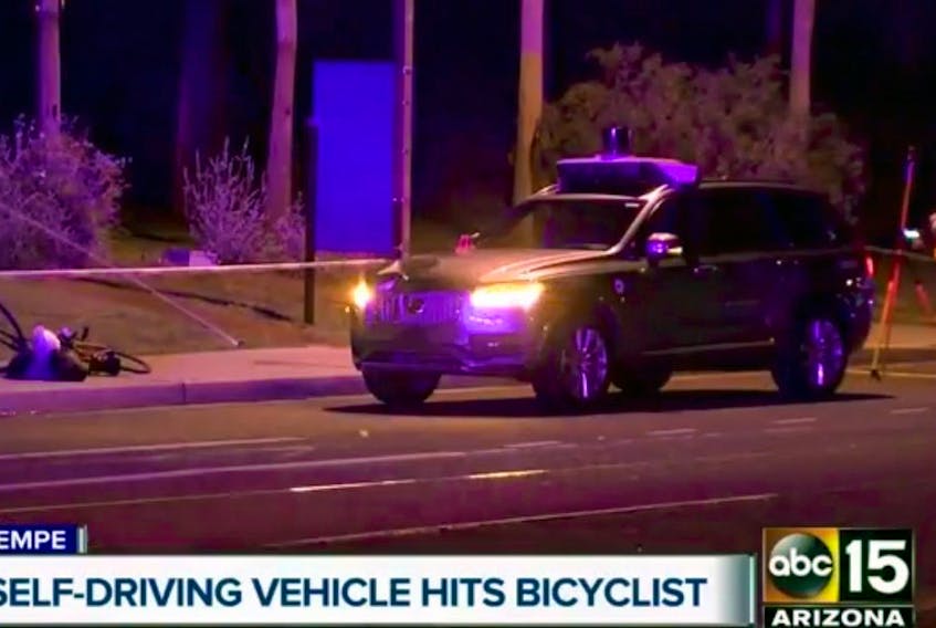 This March 19, 2018 still image taken from video provided by ABC-15, shows investigators at the scene of a fatal accident involving a self-driving Uber car on the street in Tempe, Ariz. Police in the city of Tempe said the vehicle was in autonomous mode with an operator behind the wheel when the woman walking outside of a crosswalk was hit.