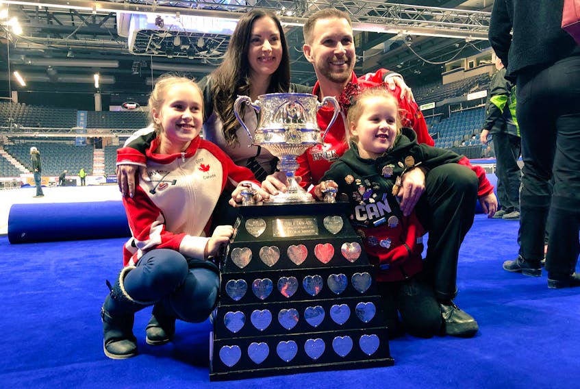 Brad Gushue and his wife Krista pose with daughters Hayley (left) and Marissa around the Brier Tankard after his rink won the 2017 Brier Canadian men’s curling championship in St. John’s. — Curling Canada/Twitter