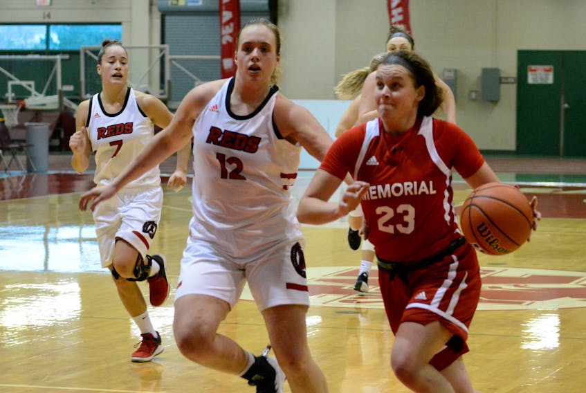 Memorial Sea-Hawks guard Haille Nickerson (23) moves around Sara Fudge of the UNB Reds during AUS women’s basketball play at the Field House in St. John’s earlier this month. Nickerson and the Sea-Hawks are back on home court this weekend as they take on the league-leading Acadia Axewomen 6 p.m. this evening and noon on Sunday. — Memorial Athletics