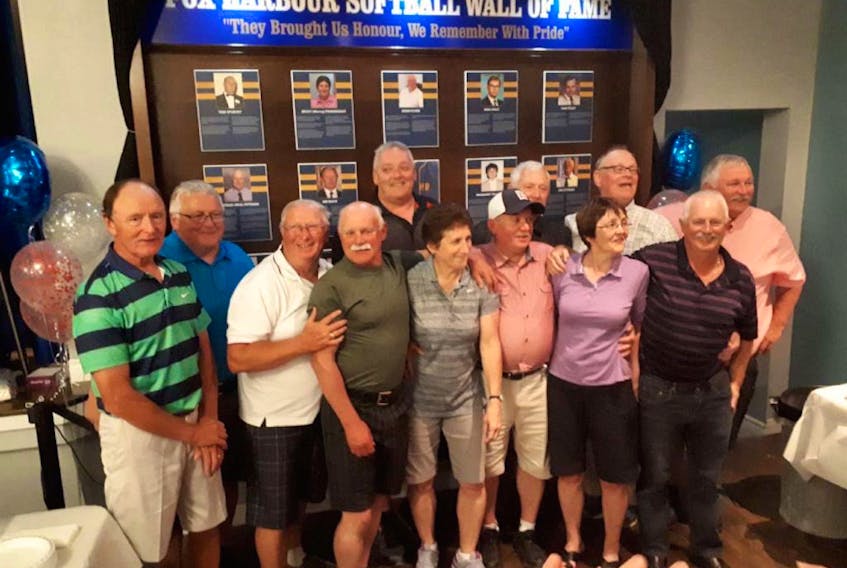 The Fox Harbour Softball Wall of Fame was unveiled earlier this summer at the Fox Harbour Community Centre. On hand were 12 of the 14 honorees, including (left to right), front row: Jim Davis, Derm Flynn, Jim Pittman, Becky (Murray) Pendergast, Pat Kelly, Rose (Foley) Kelly, and Wish Pittman; back row: Mike Davis, Dick Davis, Dan Foley, Mike Kelly and Bill Davis. The late Mag Davis and Tom Spurvey are the others whose names are all the wall.