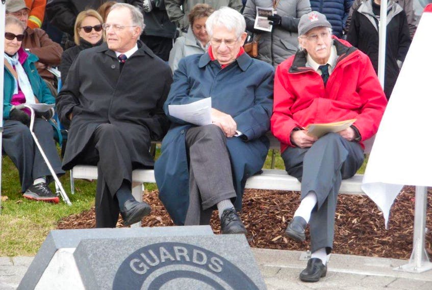 Taking part in the unveiling of the Ayre Athletic Grounds Memorial were, from left, Miller Ayre, guest speak Ed Roberts and Bill Campbell, chairman of the Guards Athletic Association.