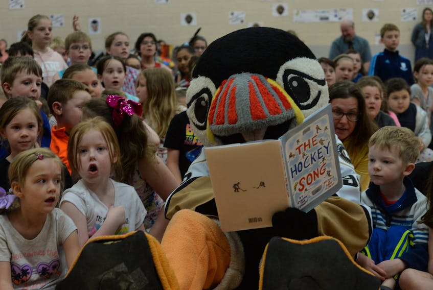 Newfoundland Growlers mascot Buddy the Puffin joined students and staff at St. Matthew’s School in Cowan Heights on Thursday morning to kick off the 2019 Newfoundland Growlers Buddy’s Book Club. Students are encouraged to read for 20 minutes a day (comparable to a school recess) this summer and track their success on a form to return to their school in September. Students will then have their name submitted for a chance to win prizes. Above, Buddy and kindergarten students at St. Matthew’s read the book “The Hockey Song,” by Stompin’ Tom Connors, with illustration by Gary Clement.