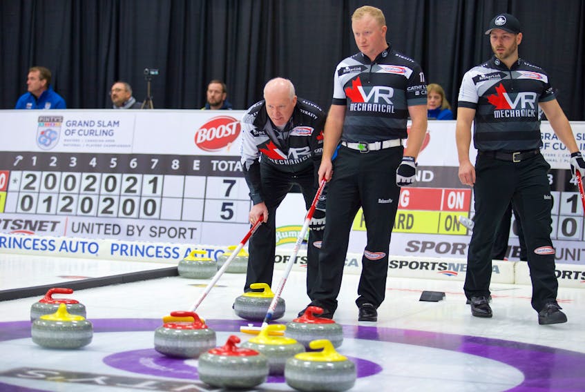 Grand Slam if Curling/Anil Mungal - Curling Hall of Famer Glenn Howard, left, says the opportunity to play with his son, Scott (next to Glenn), is a big reason why he’s still playing the game at age 56.