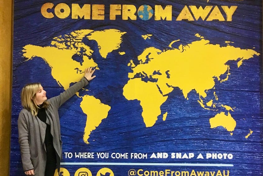 Conche native Toni Kearney poses in front of a "Come From Away" poster in Melbourne, Australia.