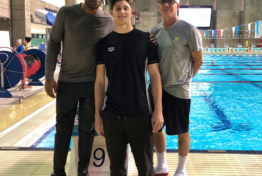 Owen Daly thoroughly loves training at the CAMO Swimming Aquatic Club in Montreal, under coaches Greg Arkhurst, left, and Claude St. Jean.