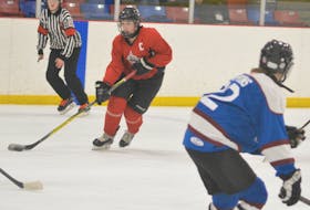 St. John’s North forward Abby Newhook (left) makes a move on a Mount Pearl South defenceman during round robin play this week at the 2018 Newfoundland and Labrador Winter Games in Deer Lake.