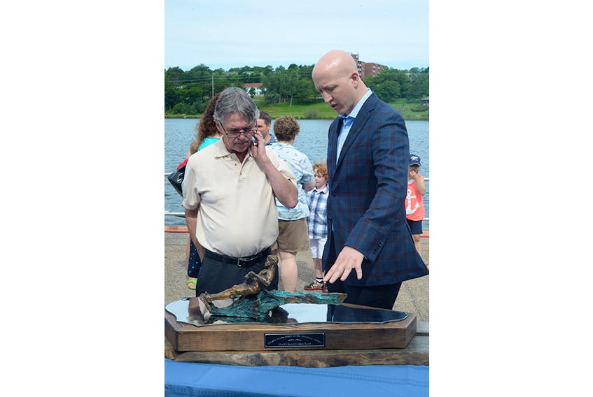 In an unveiling at the Royal St. John’s Regatta boathouse Friday morning, sculptor Morgan MacDonald, right, and Bob Angel, son of Regatta legend Gerry Angel, unveiled the new Molson Coors Gerry Angel Memorial Trophy for the men’s championship race winner.