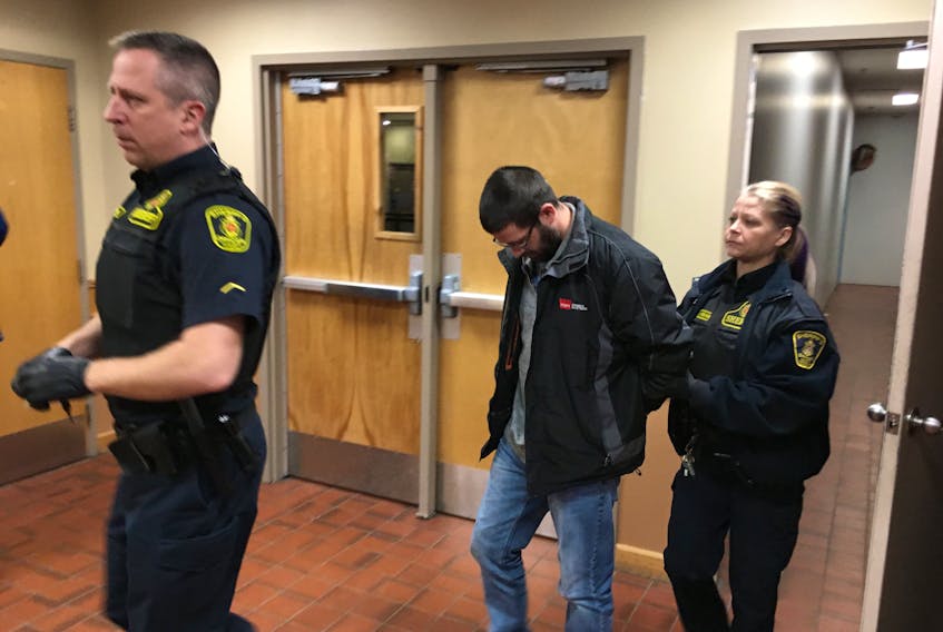 Second-degree murder suspect in the death of Victoria Head, Steve Bragg, is led into court Saturday morning. — David Maher/The Telegram