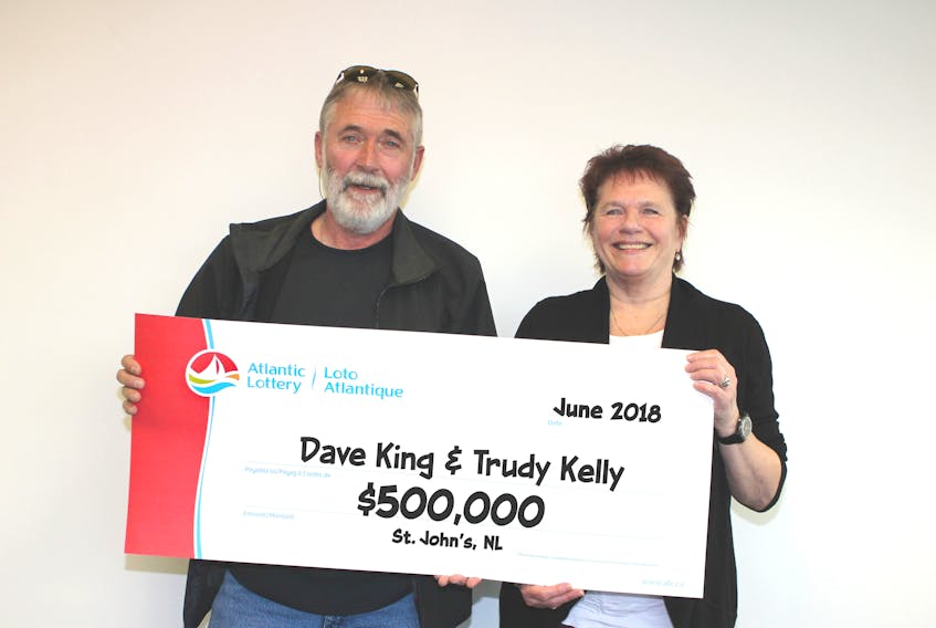 St. John's couple Dave King and Trudy Kelly hold their cheque for $500,000 which they won on a free ticket last Friday.