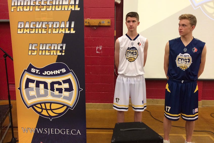 Daffyd Banfield, left, and Caleb d'Entremont model the jerseys that will be worn by the newest National Basketball League of Canada franchise, the St. John's Edge. The team unveiled its name, logo and colours at a ceremony Monday morning at Macdonald Drive Junior High. — Joe Gibbons/The Telegram