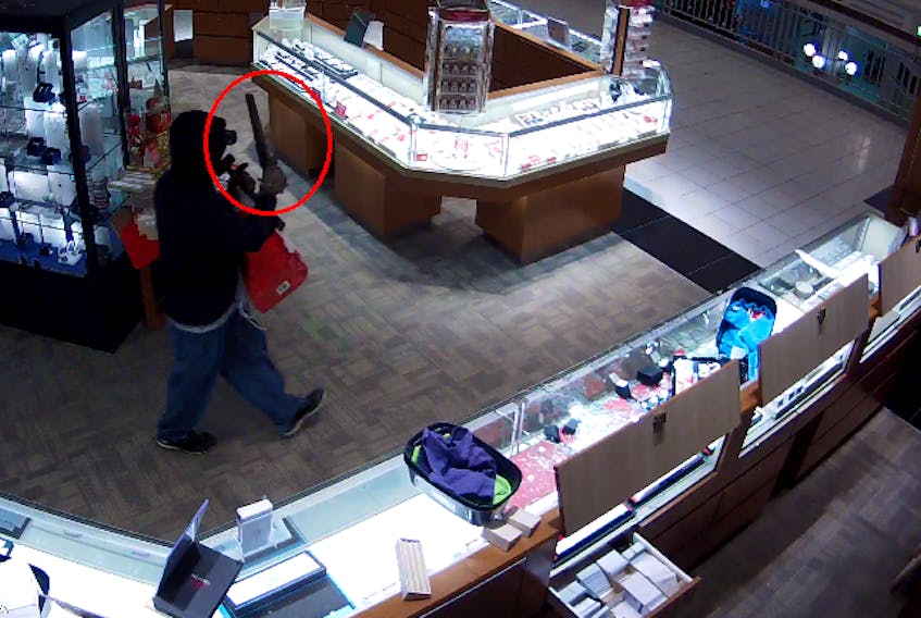 Submitted  — An armed robber is shown in security camera footage from Charm Diamond Centre at The Village Thursday night.