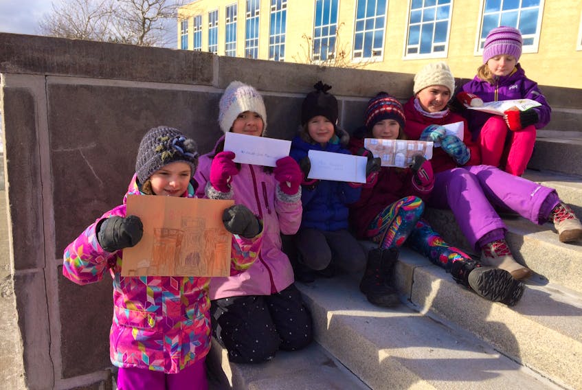 Displaced Bishop Feild students (from left) Lily Halley-Green, Gianna Binetta, Georgia Cavanagh, Fiona Cavanagh, Andie Noseworthy and Anna Murphy sit on the steps of Confederation Building displaying the letters they were about to hand deliver to government officials.