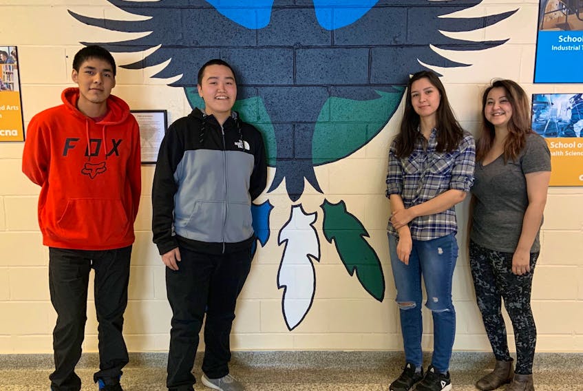 College of the North Atlantic Aboriginal Bridging program students Paulette Rice, Carrie McNeill, Courage Pastitshi and Sidney Blake-Pijogge with the ‘Flight of Resilience’ mural designed by Indigenous Artist Lisa Learning.