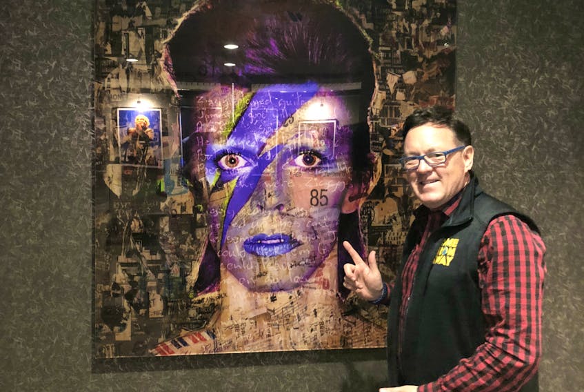 Kevin Tuerff poses with David Bowie art in The Jag Boutique Hotel in St. John’s. John Steele, who owns all hotels in Gander, also personally chose the rock star artwork throughout the hotel.