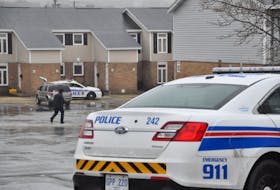 An RNC officer walks towards Building 12 on Wigmore Court in St. John's.