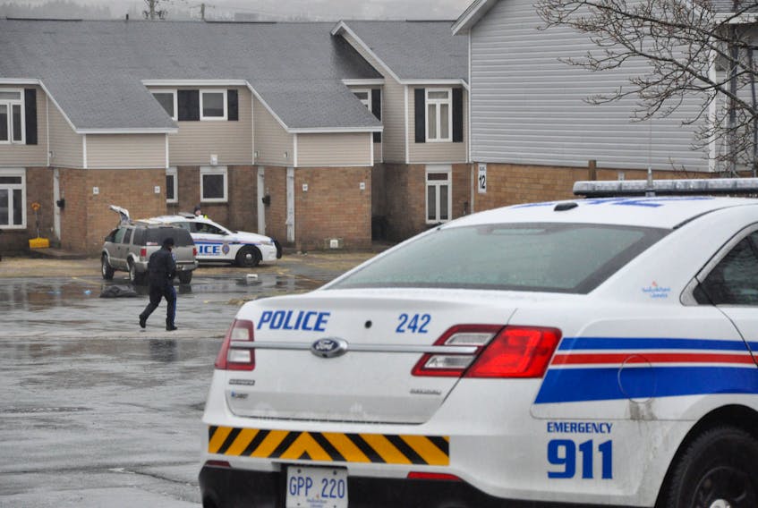 An RNC officer walks towards Building 12 on Wigmore Court in St. John's.