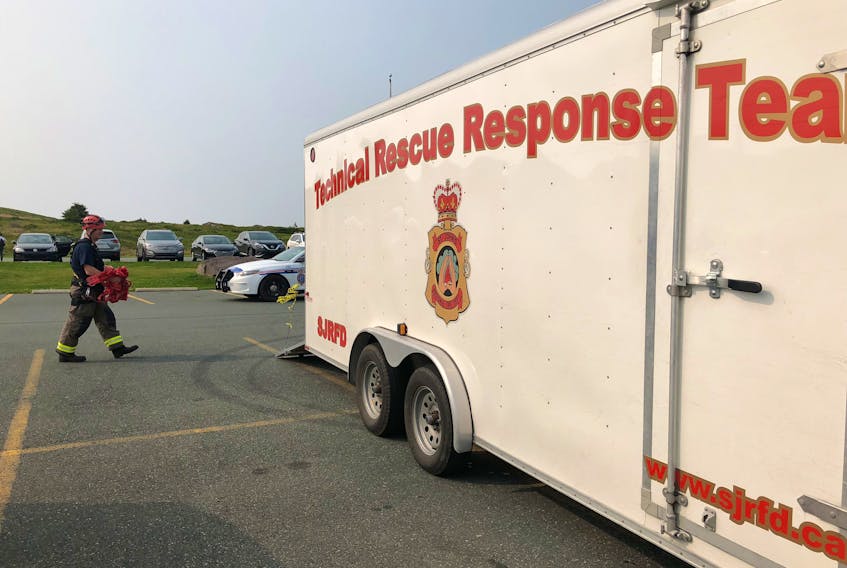 A member of the high angle rescue technical response team puts away equipment and police tape after multiple emergency responders rushed to Cape Spear early this morning when a woman fell to her death.