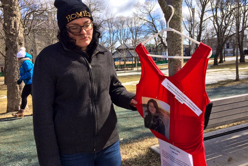 Rosie Hoskins, first cousin of Conner River's Chantele John, who was murdered in January, placed a red dress on a tree in Bannerman Park on Wednesday, which would have been John's 29th. birthday.