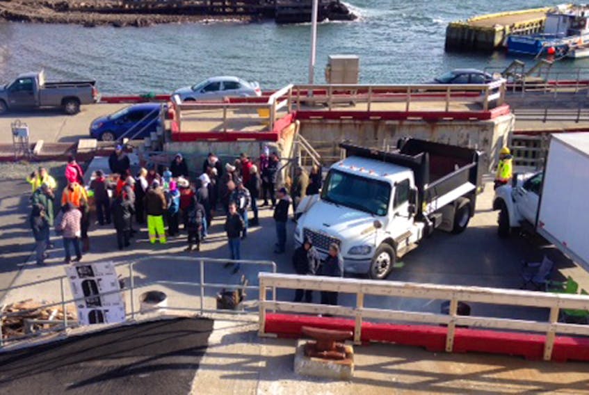 A group of protesters in Bell Island are using several large trucks in front of the Legionnaire on Monday morning to block government from moving it from their run to Fogo Island.