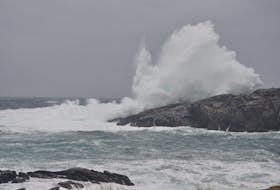Waves crash over the rocks entering the mouth of the harbour in Port aux Basques on Friday.