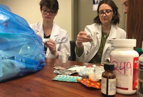 Memorial University pharmacy students Laura Fleming and Rachel Ward sort through some of the medications dropped off at the Royal Newfoundland Constabulary headquarters Sunday afternoon.