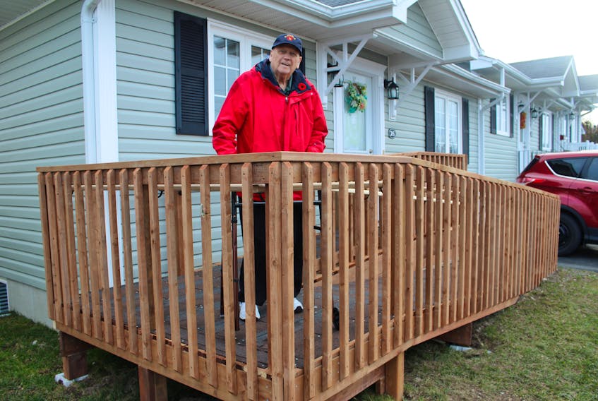 Sam McNeish/The Telegram — 
Bob Corbett stands proudly on the ramp that allows him easy access into his home on Gisborne Place in St. John’s. His former firefighting colleagues — who answered the call when they saw their friend was in need — built the ramp for him.