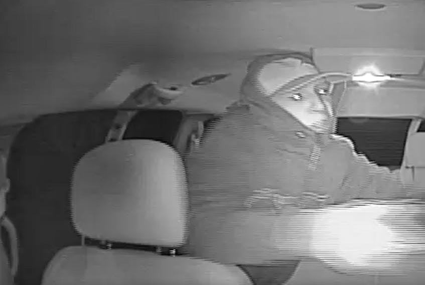 An image taken from CCTV footage shows a robbery suspect inside a taxi on Tuesday.