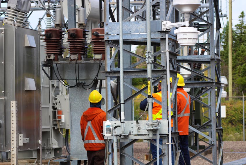 Employees with Newfoundland Power inspect a malfunctioning breaker at the Kenmount Road substation in St. John’s on Thursday morning.