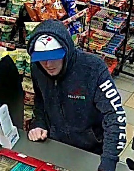 The man is described as about 6’ tall with blue eyes. At the time of the robbery, he was wearing a black hoodie, a Blue Jays hat, and light coloured jogging pants.