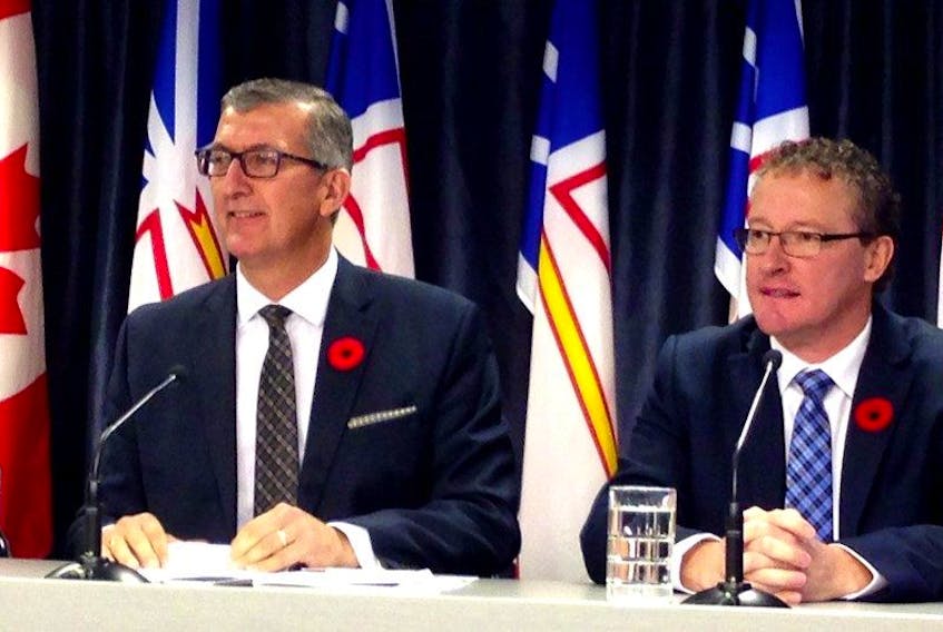 Then Premier Paul Davis (left) and then Natural Resources Minister Derrick Dalley are shown in this file photo. — Telegram file photo