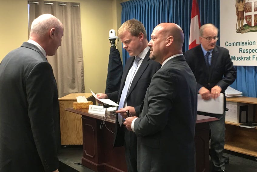Before he begins testimony at the Muskrat Falls Inquiry, Charles Bown (third from left) speaks to Inquiry co-counsel Barry Learmonth (far left) and his lawyer, Andrew Fitzgerald (second from left).