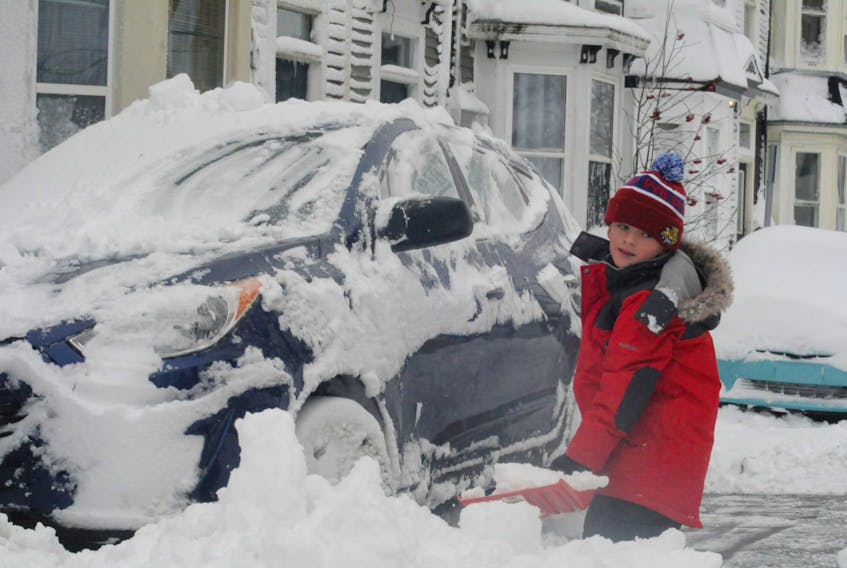 Max Soper, 6, helps his parents shovel out their Hyunday Tuscon Monday afternoon in front of their downtown St. John’s home. They were among the thousands of residents on the Avalon Peninsula who were digging out from Sunday night into Monday morning’s snowstorm that dumped 41 centimetres of snow on the metro region.