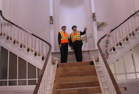 Tourism, Culture, Industry and Innovation Minister Christopher Mitchelmore (left) looks around the grand stairway at the entrance of Colonial Building along with MHA Mark Browne.