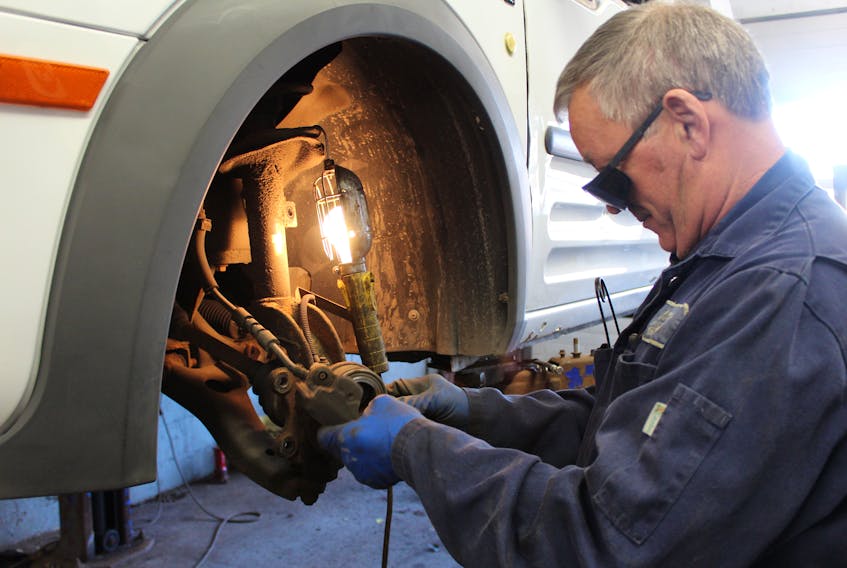 Ed Hearn, a technician at Morris Service Station Ltd. on Freshwater Road in St. John’s, replaces front brakes on a vehicle in preparation for winter driving.