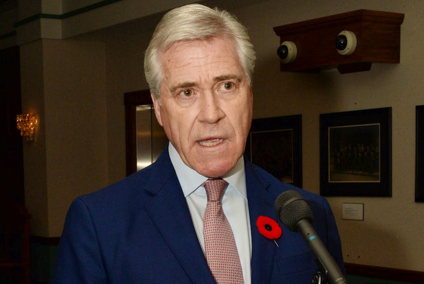 Premier Dwight Ball speaks to reporters outside the House of Assembly in St. John’s Monday.