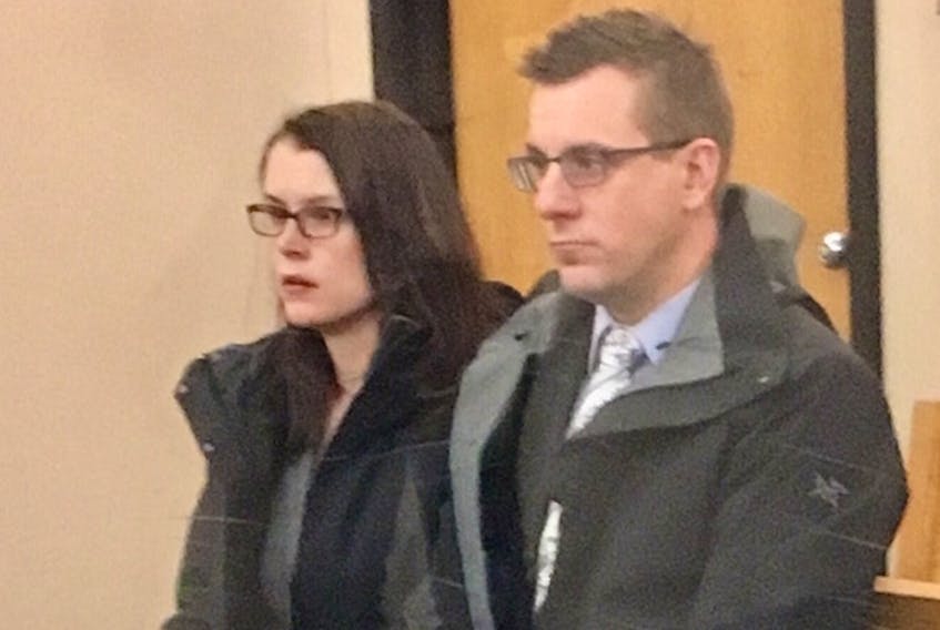 RNC Const. Joe Smyth sits with his wife in provincial court in St. John's on Tuesday.