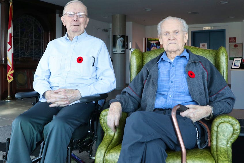 Veterans James Samuel Miller, 81, (left) and James Kirby, 94, discuss their thoughts on Remembrance Day at the Caribou Memorial Veterans Pavilion in St. John’s Friday.