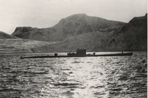Type XTC/40 submarine U-537 at anchor in Martin Bay, Labrador, Dominion of Newfoundland (now Canada), Oct. 22, 1943. Crewmen can be seen on deck offloading components of Weather Station Kurt into rubber rafts. — Archival photo