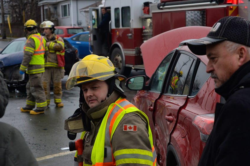 St. John’s Regional Fire Department firefighter Chad Walsh speaks with the occupants of two vehicles involved in an accident at the intersection of Empire Avenue and Freshwater Road on Tuesday afternoon.