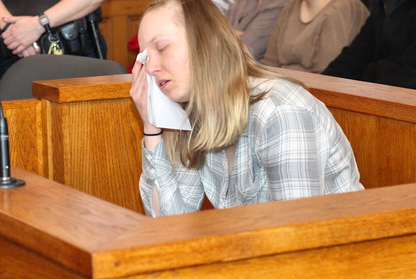 Anne Norris wipes her eyes in the dock in Newfoundland and Labrador Supreme Court in St. John’s Monday morning. A jury now selected, her first-degree murder trial is due to begin Monday morning