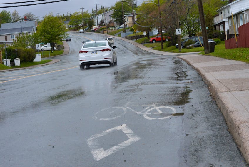 Fading bicycle lane markings on Cowan Avenue just past the turnoff from Topsail Road heading north toward Canada Drive.
