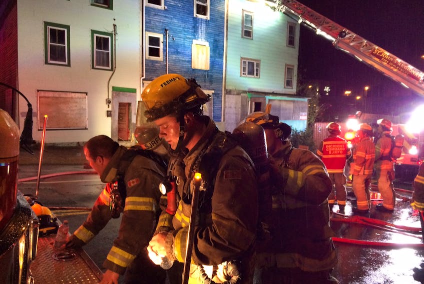 Firefighters at the scene of a house fire Friday night on the corner of Springdale and New Gower streets in St. John’s.