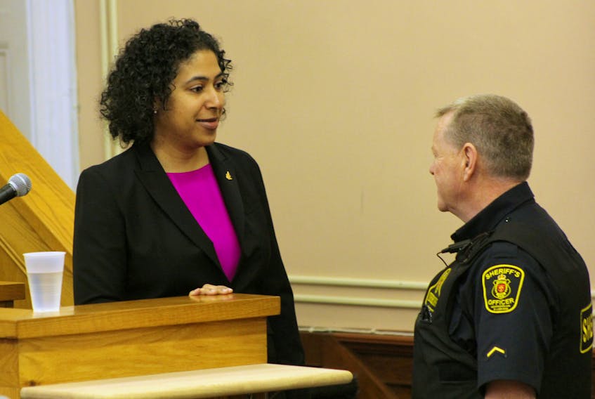 Forensic DNA specialist Florence Celestin chats with a sheriff’s officer at Newfoundland and Labrador Supreme Court in St. John’s Tuesday, during a break in her testimony at the murder trial of Brandon Phillips.